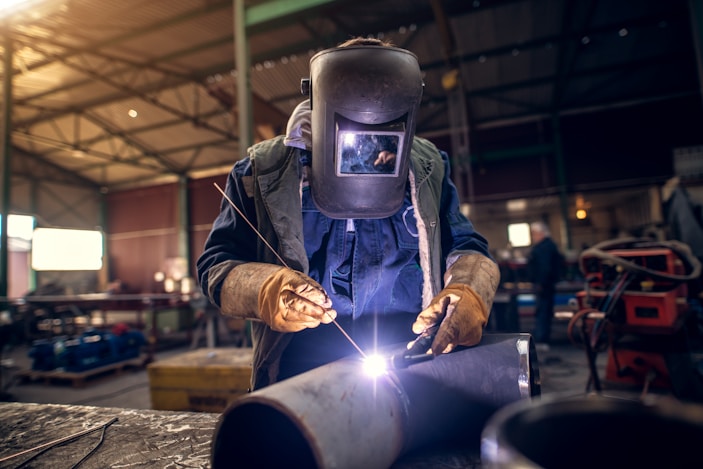 Person welding in workshop